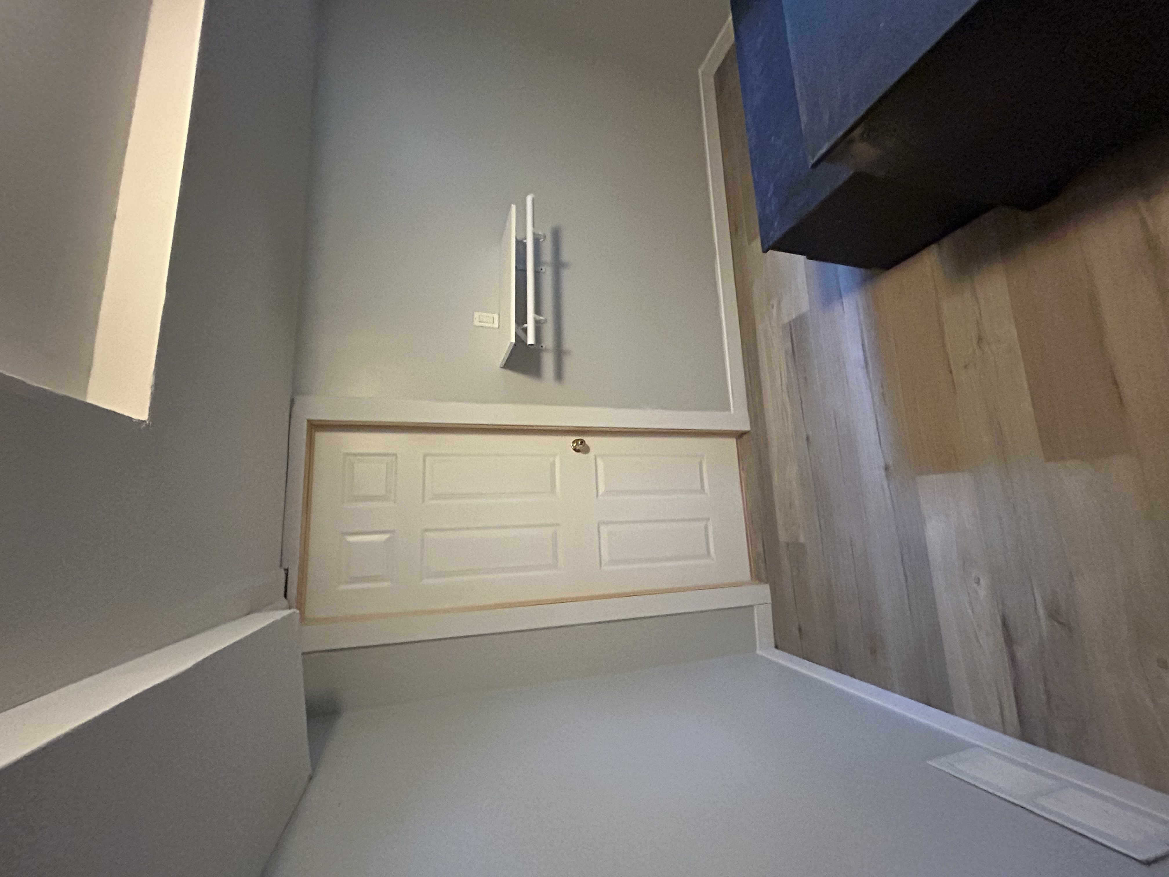 LVP flooring and baseboard install in a basement bedroom, with interior door hung and cased.